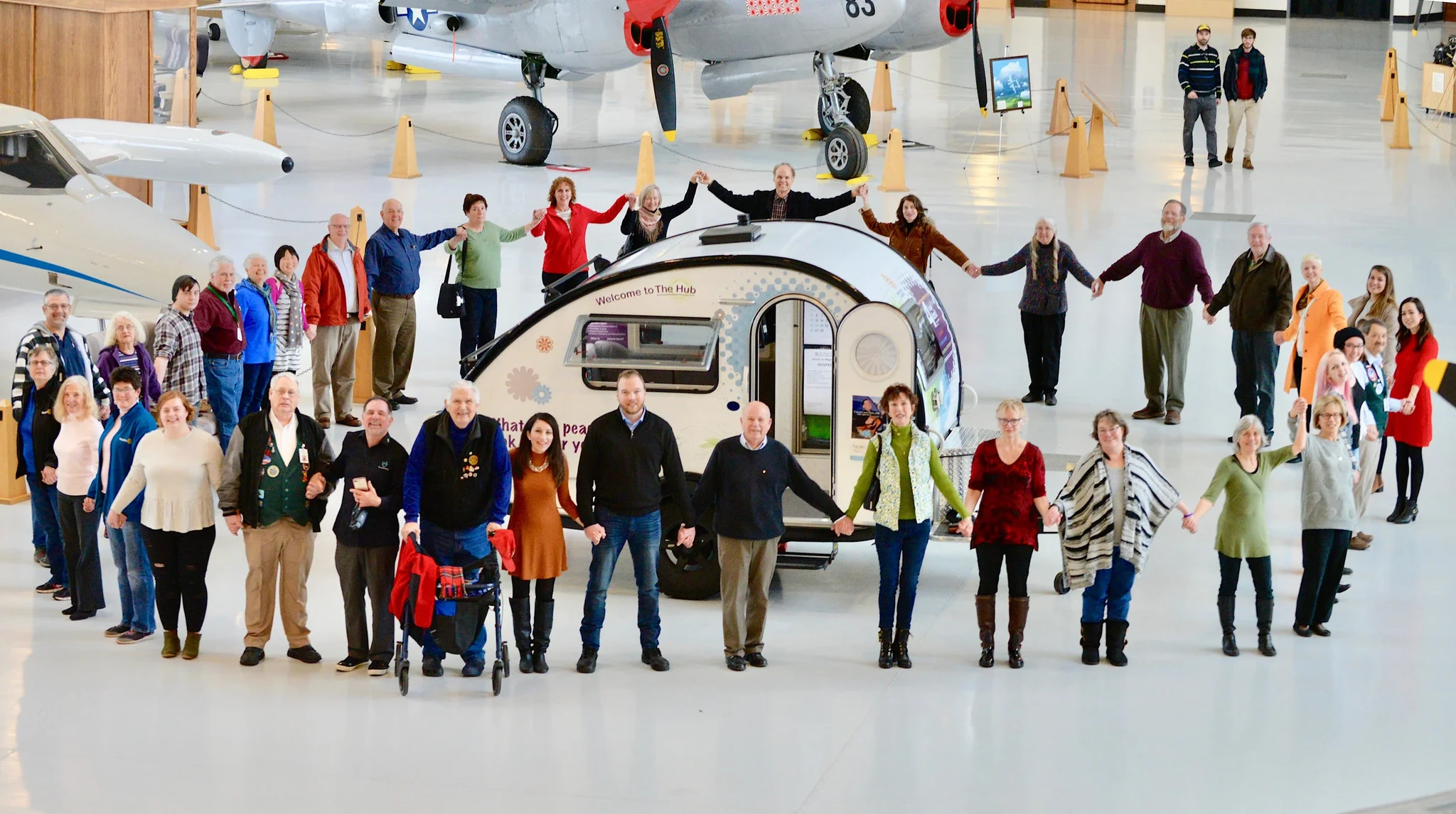 Rotarian Peacebuilders in District 5100 gather at The Hub Peacebuilder Tour Launch in McMinnville, Oregon beneath the wing of the Spruce Goose.